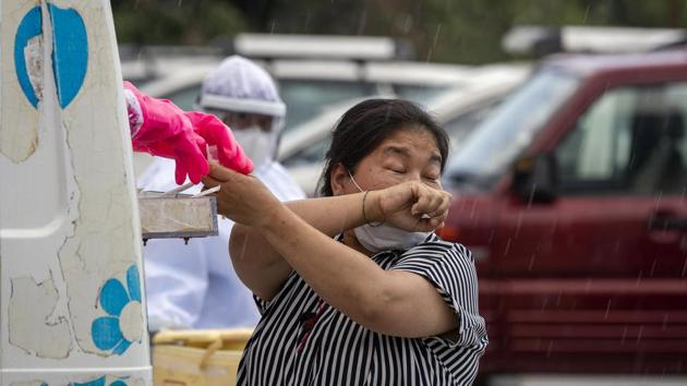 A woman sneezes as a doctor prepares to take a nasal swab to be tested for the coronavirus in Dharmsala, India, Saturday, May 9, 2020. India relaxed some coronavirus lockdown restrictions on Monday even as the pace of infection picked up and reopenings drew crowds of people. (AP Photo/Ashwini Bhatia) (AP) A woman sneezes as a doctor prepares to take a nasal swab to be tested for the coronavirus in Dharmsala, India, Saturday, May 9, 2020. India relaxed some coronavirus lockdown restrictions on Monday even as the pace of infection picked up and reopenings drew crowds of people. (AP Photo/Ashwini Bhatia) (AP)