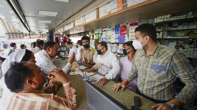 Salesmen at a chemist shop wear protective masks in wake of the deadly novel coronavirus.(PTI) Salesmen at a chemist shop wear protective masks in wake of the deadly novel coronavirus.(PTI)