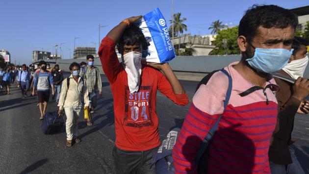 Migrant workers seen walking with their belongings on the Eastern Express Highway between Ghatkopar and Kanjurmarg in Mumbai. Many who couldn’t board the Shramik Special trains for a host of reasons have set off on arduous journeys on foot. (Satish Bate / HT Photo) Migrant workers seen walking with their belongings on the Eastern Express Highway between Ghatkopar and Kanjurmarg in Mumbai. Many who couldn’t board the Shramik Special trains for a host of reasons have set off on arduous journeys on foot. (Satish Bate / HT Photo)