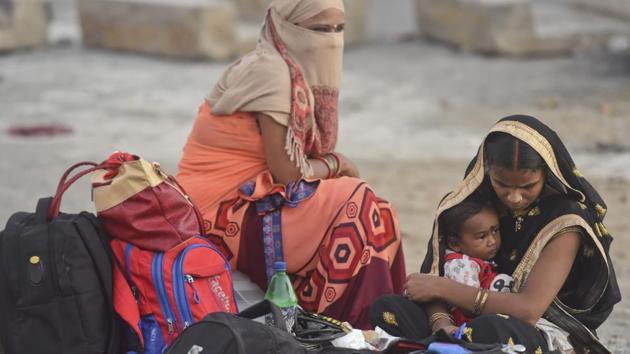 Two women with a child during a small halt at the Eastern Exress Highway between Thane and Bhiwandi in the wee hours of the morning on May 9. Some states are charging migrants for their train journeys, while some others had tried to bar them from going home. (Satish Bate / HT Photo) Two women with a child during a small halt at the Eastern Exress Highway between Thane and Bhiwandi in the wee hours of the morning on May 9. Some states are charging migrants for their train journeys, while some others had tried to bar them from going home. (Satish Bate / HT Photo)