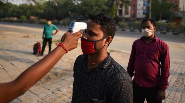 A migrant worker undergoes thermal screening at Delhi’s Yamuna Sports Complex which turned into a shelter home, during nationwide lockdown to curb the spread of coronavirus. (Biplov Bhuyan/HT PHOTO) A migrant worker undergoes thermal screening at Delhi’s Yamuna Sports Complex which turned into a shelter home, during nationwide lockdown to curb the spread of coronavirus. (Biplov Bhuyan/HT PHOTO)