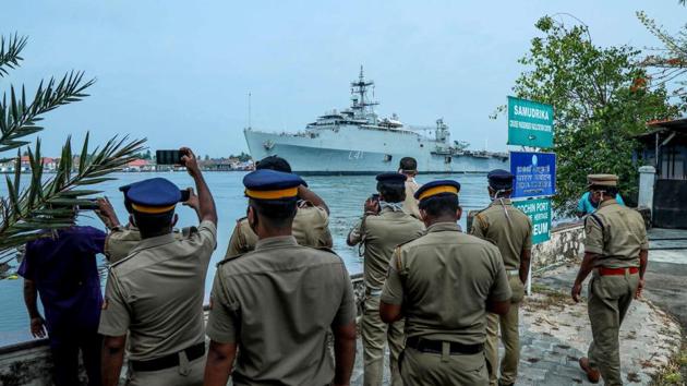 Police personnel watch and take photos as the INS Jalashwa ship enters the Cochin port carrying Indian citizens who were stranded in Maldives due to the COVID-19 coronavirus disease, in Kochi, Kerala on May 10. INS Jalashwa is the first ship to bring home Indians stranded abroad as part of Operation Samudra Setu. (Arunchandra Bose / AFP) Police personnel watch and take photos as the INS Jalashwa ship enters the Cochin port carrying Indian citizens who were stranded in Maldives due to the COVID-19 coronavirus disease, in Kochi, Kerala on May 10. INS Jalashwa is the first ship to bring home Indians stranded abroad as part of Operation Samudra Setu. (Arunchandra Bose / AFP)