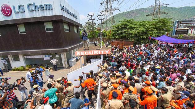 Police personnel try to control the villagers as they stage a protest against LG Polymers industry after the chemical gas leakage incident, demanding immediate closure of the plant, at RR Venkatapuram village in Visakhapatnam.(PTI)