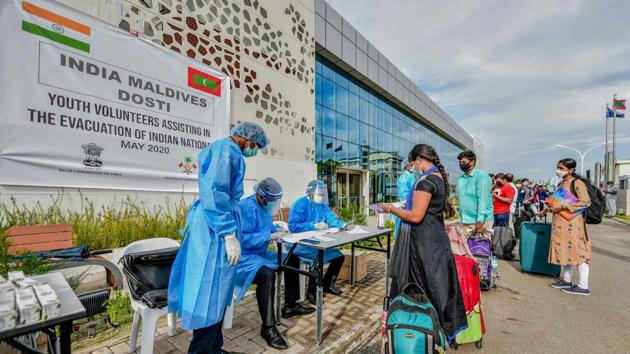 High Commission officials and volunteers in protective gear check Indian citizens going to the Velana International Airport for visa procedures before boarding the INS Jalashwa, in Male on May 8. Evacuees were screened medically, their baggage disinfected and were allotted IDs as per zones earmarked on board the ship. (Ahmed Shurau / AFP) High Commission officials and volunteers in protective gear check Indian citizens going to the Velana International Airport for visa procedures before boarding the INS Jalashwa, in Male on May 8. Evacuees were screened medically, their baggage disinfected and were allotted IDs as per zones earmarked on board the ship. (Ahmed Shurau / AFP)