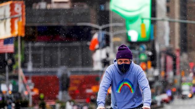 A man cycles through Times Square during a snow flurry as a polar vortex brought cold temperatures to the region in the Manhattan borough of New York City, US. (REUTERS)