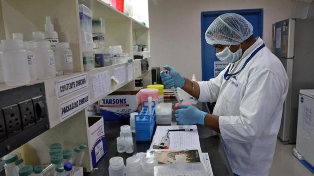 A research scientist works on a testing kit for the coronavirus disease inside a laboratory of GCC Biotech during the outbreak of the disease on the outskirts of Kolkata.(Reuters Photo)