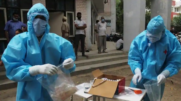 Medical workers collect swab samples from Haryana Police personnel for Covid-19 tests, during a nationwide lockdown due to coronavirus pandemic, at Police Line, in Gurugram. (Yogendra Kumar/HT PHOTO) Medical workers collect swab samples from Haryana Police personnel for Covid-19 tests, during a nationwide lockdown due to coronavirus pandemic, at Police Line, in Gurugram. (Yogendra Kumar/HT PHOTO)