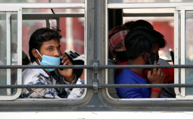 Migrant workers arrive at Amritsar railway station to board the Shramik Special train for their home states, during nationwide lockdown to check the spread of coronavirus on Sunday.(Sameer Sehgal/HT Photo)