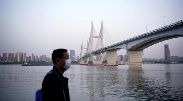 A man wearing a face mask is seen under a bridge of Yangtze river in Wuhan after the lockdown was lifted, on April 15.(Reuters File Photo) A man wearing a face mask is seen under a bridge of Yangtze river in Wuhan after the lockdown was lifted, on April 15.(Reuters File Photo)