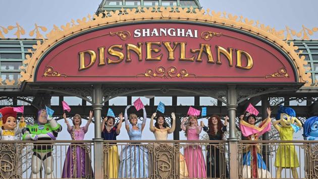 Performers dressed as Disney characters are seen during the reopening of the park. Disney said it is limiting access to the Shanghai park to a fifth of normal capacity, below the government-mandated 30%, during the initial reopening phase, reported Bloomberg. (Hector Retamal / AFP)