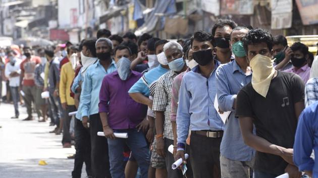 Migrants gathered in large number for travel pass were sent back by Police at Dharavi Police Station in Mumbai, India, on Sunday, May 10, 2020. (Hindustan Times) Migrants gathered in large number for travel pass were sent back by Police at Dharavi Police Station in Mumbai, India, on Sunday, May 10, 2020. (Hindustan Times)