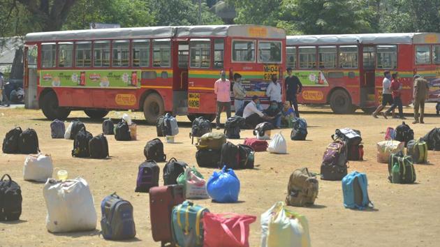 Belongings of migrant workers are seen on the ground as they wait to board buses outside a police station in Thane. Ever since a nationwide lockdown was announced starting March 25, migrant workers from across the country began to walk and cycle back to their home states even as a few states deployed buses to ferry some of them home. (Mitesh Bhuvad / PTI) Belongings of migrant workers are seen on the ground as they wait to board buses outside a police station in Thane. Ever since a nationwide lockdown was announced starting March 25, migrant workers from across the country began to walk and cycle back to their home states even as a few states deployed buses to ferry some of them home. (Mitesh Bhuvad / PTI)