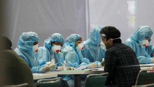 Indian nationals, who were stranded in Singapore due to the coronavirus disease (Covid-19) outbreak, are screened by medics wearing personal protective equipment (PPE) at the airport upon their arrival in New Delhi, India.(REUTERS)
