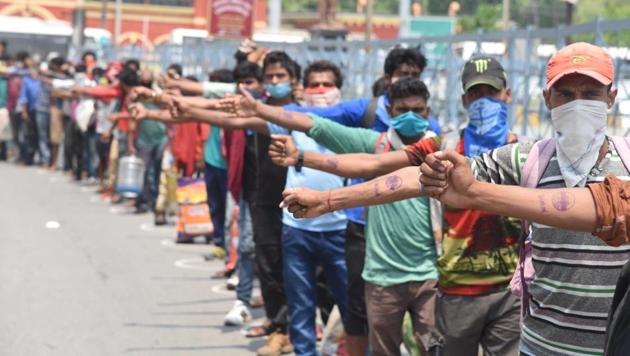 Migrant workers show their hand marked with quarantine stamp upon their arrival by a special train, during lockdown, in Danapur station, Patna, Bihar on Sunday. (Santosh Kumar/HT Photo) Migrant workers show their hand marked with quarantine stamp upon their arrival by a special train, during lockdown, in Danapur station, Patna, Bihar on Sunday. (Santosh Kumar/HT Photo)