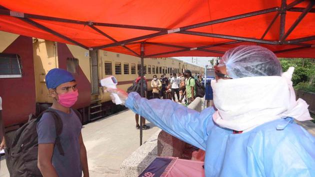 A migrant worker undergoes thermal screening upon his arrival by a special train, during lockdown, in Danapur station, Patna, on Sunday. (Santosh Kumar/HT Photo) A migrant worker undergoes thermal screening upon his arrival by a special train, during lockdown, in Danapur station, Patna, on Sunday. (Santosh Kumar/HT Photo)