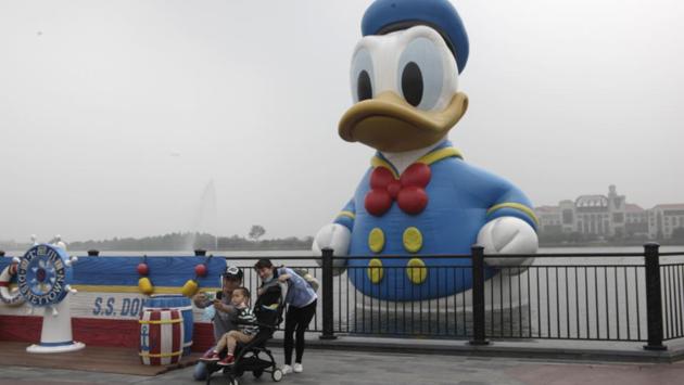 Visitors take a selfie with a giant Donald Duck installation in Disneyland theme park in Shanghai. The park reopened on May 11 after almost four months since it was shut down due to the coronavirus pandemic. (Chen Si / AP)