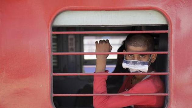 A migrant workers sits inside a special train to return to Agra in Uttar Pradesh state during a nationwide lockdown to curb the spread of new coronavirus. (AP) A migrant workers sits inside a special train to return to Agra in Uttar Pradesh state during a nationwide lockdown to curb the spread of new coronavirus. (AP)