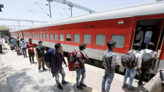Migrants, stranded in different parts of Gujarat, boarding a special train to Odisha during the nationwide lockdown, imposed in wake of the coronavirus pandemic, at a railway station in Ahmedabad. (PTI) Migrants, stranded in different parts of Gujarat, boarding a special train to Odisha during the nationwide lockdown, imposed in wake of the coronavirus pandemic, at a railway station in Ahmedabad. (PTI)