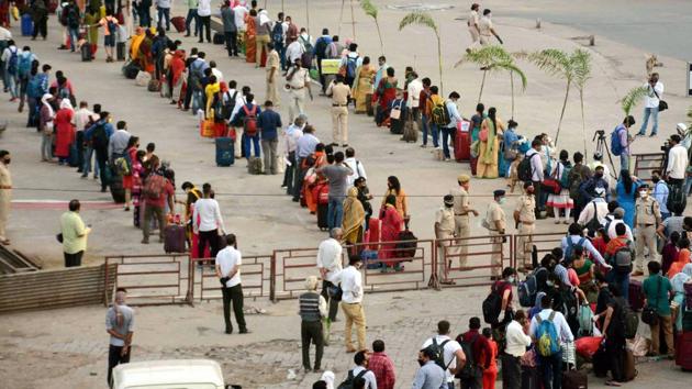 Long queues of people seen waiting to enter Patna junction to board a train. In an unprecedented measure, the railways, called the lifeline of the country, had suspended passenger service from March 22 midnight leaving countless people stranded during the coronavirus lockdown. (PTI) 