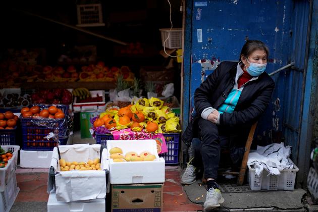 FILE PHOTO: A woman wearing a face mask sits next to a fruit stall at a residential area after the lockdown was lifted in Wuhan, capital of Hubei province and China's epicentre of the novel coronavirus disease (Covid-19) outbreak. (REUTERS) FILE PHOTO: A woman wearing a face mask sits next to a fruit stall at a residential area after the lockdown was lifted in Wuhan, capital of Hubei province and China's epicentre of the novel coronavirus disease (Covid-19) outbreak. (REUTERS)