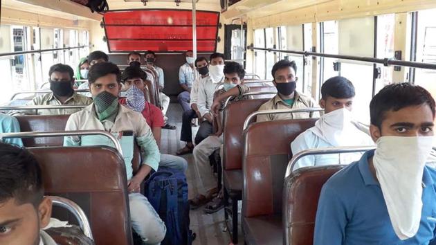 The migrants, who have all paid Rs 3,000 or more for each of their tickets, are now refusing to step out of the bus. . (HT PHOTO)