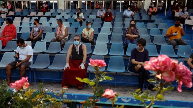 Stranded residents of Ladakh, a union territory in India, wait in a stadium for being thermal screened before taking buses back to Ladakh, after few restrictions were lifted by Delhi government during an extended nationwide lockdown to slow the spread of the coronavirus disease (COVID-19), in New Delhi.(REUTERS)