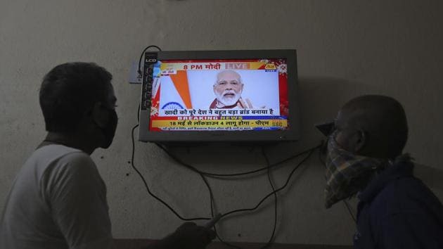 Indians watch a televised address to the nation by Prime Minister Narendra Modi in Hyderabad, India.(AP)