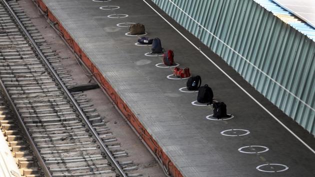Passengers leave their bags in a queue, with circles marked for observing social distancing, to reserve their spots to board a train in New Delhi. Passengers were allowed to enter the stations only if they were asymptomatic and cleared thermal screening. They are required to maintain social distancing on board and are given hand sanitizers when they enter and leave. (Manish Swarup / AP) 