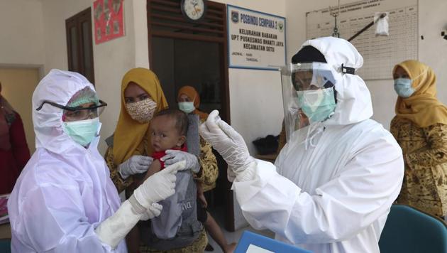 Health workers in protective gear prepare the measles vaccine to be given to baby at a community health center in Tangerang, Indonesia, Tuesday, May 12, 2020. (Representational)(AP)