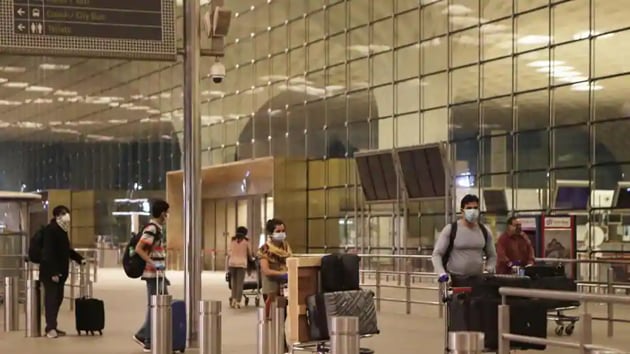 Passengers arrive to take an Air India flight that will travel to London to bring back Indians from London, at Chhatrapati Shivaji International Airport in Mumbai.(AP Photo)