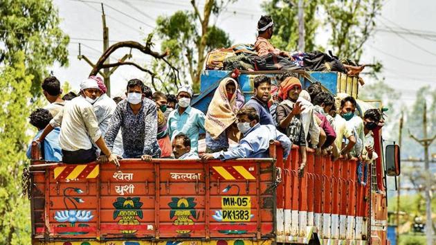 Migrants coming from Maharashtra board a truck to reach their native places in Uttar Pradesh and Jharkhand, amid the ongoing COVID-19 nationwide lockdown in Bhopal on Tuesday.(PTI Photo)