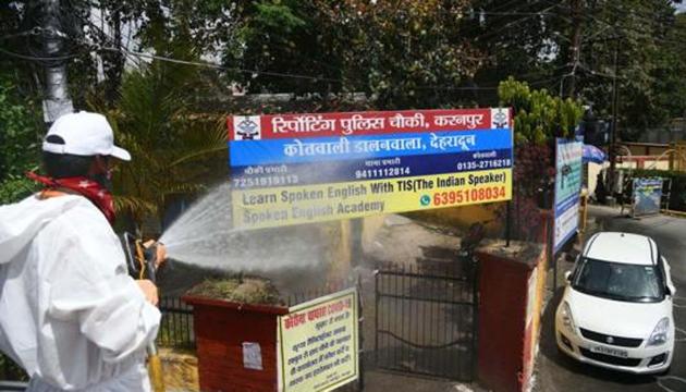 A firefighter sprays disinfectant at a police station during a nationwide lockdown in the wake of coronavirus pandemic, in Dehradun, Tuesday, April 14, 2020. (PTI) A firefighter sprays disinfectant at a police station during a nationwide lockdown in the wake of coronavirus pandemic, in Dehradun, Tuesday, April 14, 2020. (PTI)