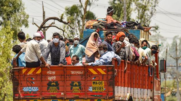Migrants coming from Maharashtra board a truck to reach their native places in Uttar Pradesh and Jharkhand, amid the ongoing COVID-19 nationwide lockdown, in Bhopal, Tuesday, May 12, 2020. (PTI) Migrants coming from Maharashtra board a truck to reach their native places in Uttar Pradesh and Jharkhand, amid the ongoing COVID-19 nationwide lockdown, in Bhopal, Tuesday, May 12, 2020. (PTI)