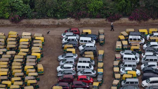 People walk past parked autos and cars in a parking during an extended nationwide lockdown to slow the spread of the coronavirus disease (COVID-19) in New Delhi. (REUTERS) People walk past parked autos and cars in a parking during an extended nationwide lockdown to slow the spread of the coronavirus disease (COVID-19) in New Delhi. (REUTERS)