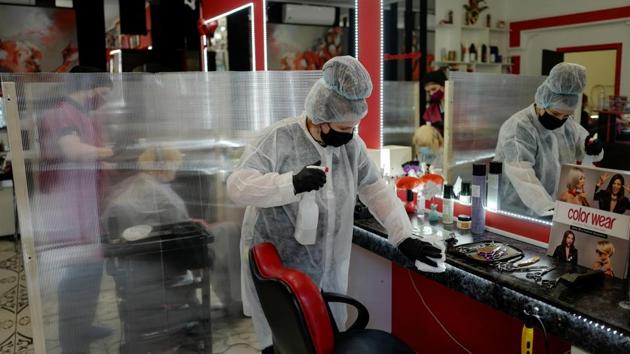 A worker wearing a protective mask and gloves cleans a hair salon after the authorities loosened lockdown restrictions amid the coronavirus (COVID-19) outbreak in Kaliningrad on May 12. (Vitaly Nevar / REUTERS)