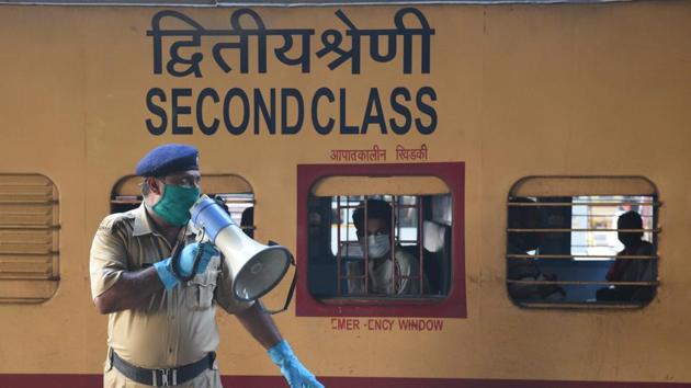 A RPF personnel speaks on the loudspeaker as passengers arrive in Howrah station from Vellore, during lockdown, in Kolkata, West Bengal, India, on Tuesday, May 12, 2020.(Photo by Samir Jana / Hindustan Times) A RPF personnel speaks on the loudspeaker as passengers arrive in Howrah station from Vellore, during lockdown, in Kolkata, West Bengal, India, on Tuesday, May 12, 2020.(Photo by Samir Jana / Hindustan Times)