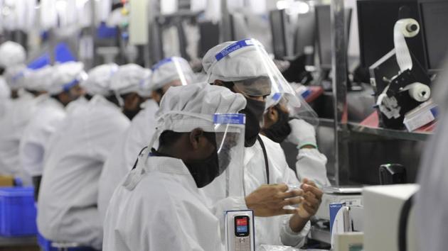 Work resumes after relaxations in lockdown restrictions at a mobile phone manufacturing facility in Sector 63, Noida. (Sunil Ghosh / Hindustan Times) Work resumes after relaxations in lockdown restrictions at a mobile phone manufacturing facility in Sector 63, Noida. (Sunil Ghosh / Hindustan Times)