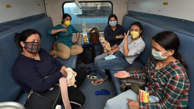 Women commuters inside a coach of the New Delhi-Dibrugarh special train at NDLS in New Delhi. The wearing of face masks has been made mandatory throughout the journeys. The government’s Aarogya Setu mobile application has also been made mandatory for travel on these special train. (Manvender Vashisht / PTI) 