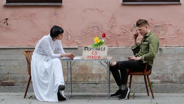 Artist Katrin Nenasheva listens to a man during her performance “Argue with me” in central Saint Petersburg. Nenasheva stages a performance in which she talks to people in streets about the problem of domestic violence during the coronavirus lockdown. (Anton Vaganov / REUTERS)