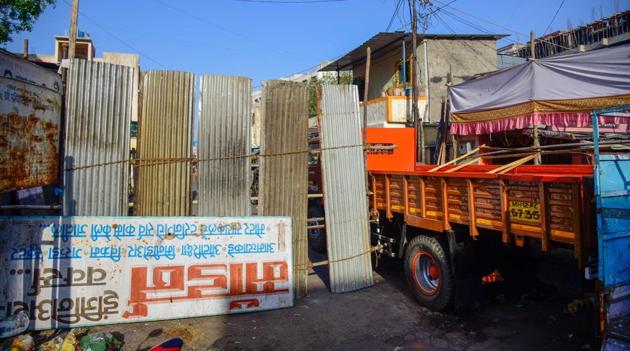 Bhavani peth area sealed with tin sheets to prevent public and vehicle movements. (SANKET WANKHADE/HT) Bhavani peth area sealed with tin sheets to prevent public and vehicle movements. (SANKET WANKHADE/HT)