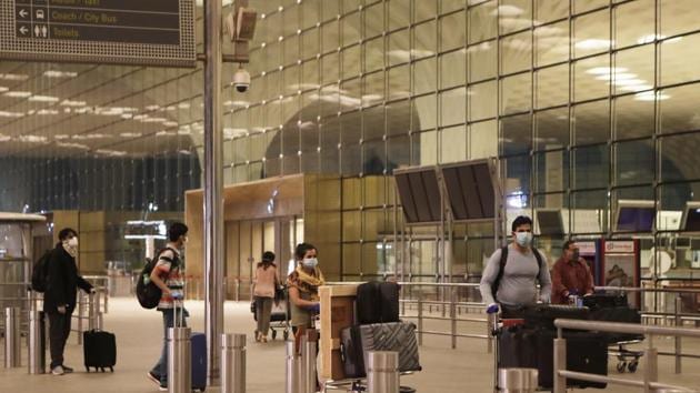 Passengers arrive to take an Air India flight that will travel to London to bring back Indians from London, at Chhatrapati Shivaji International Airport in Mumbai.(AP)