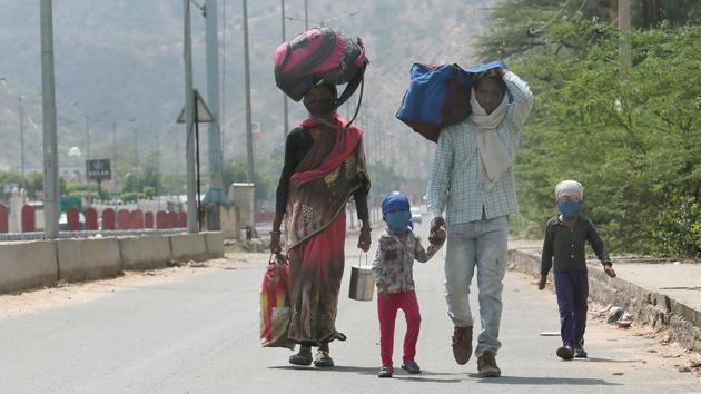 A migrant laborer, 25 year old Naresh and his 8 month pregnant wife Malti along with son Pradeep and daughter Tanu, while walking towards their home in Chhatarpur district of Madhya Pradesh, on Agra highway during third phase of Lockdown due to corona pandemic, in Jaipur on Thurssday, 14 May 2020. (Himanshu Vyas/ Hindustan Times) A migrant laborer, 25 year old Naresh and his 8 month pregnant wife Malti along with son Pradeep and daughter Tanu, while walking towards their home in Chhatarpur district of Madhya Pradesh, on Agra highway during third phase of Lockdown due to corona pandemic, in Jaipur on Thurssday, 14 May 2020. (Himanshu Vyas/ Hindustan Times)