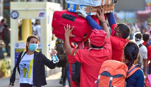 Railway porters (coolie) carry luggage of passengers arriving at a railway station to board the special train to New Delhi after the resumption of passenger train services by the Indian Railways in a graded manner amid ongoing COVID-19 lockdown, in Bengaluru, Tuesday, May 12, 2020. (PTI) Railway porters (coolie) carry luggage of passengers arriving at a railway station to board the special train to New Delhi after the resumption of passenger train services by the Indian Railways in a graded manner amid ongoing COVID-19 lockdown, in Bengaluru, Tuesday, May 12, 2020. (PTI)