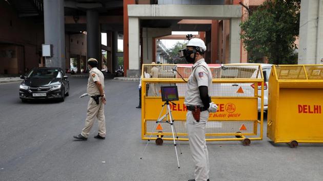 A police officer wears a "Thermal Corona Combat Headgear" to monitor the temperature of commuters at a police check post, during a nationwide lockdown to slow the spread of the coronavirus disease (COVID-19), in New Delhi. (REUTERS) A police officer wears a "Thermal Corona Combat Headgear" to monitor the temperature of commuters at a police check post, during a nationwide lockdown to slow the spread of the coronavirus disease (COVID-19), in New Delhi. (REUTERS)