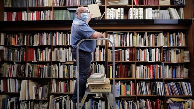 Bookseller Philippe Seyrat, wearing a protective face mask, arranges books at La Sorbonne bookstore in Nice as France softens its strict lockdown rules during the outbreak of the coronavirus disease (COVID-19) in France, May 13, 2020. REUTERS/Eric Gaillard(REUTERS) Bookseller Philippe Seyrat, wearing a protective face mask, arranges books at La Sorbonne bookstore in Nice as France softens its strict lockdown rules during the outbreak of the coronavirus disease (COVID-19) in France, May 13, 2020. REUTERS/Eric Gaillard(REUTERS)