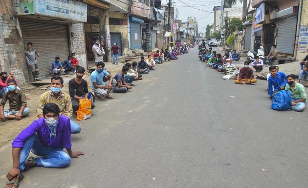 The Moradabad police stopped the workers and made them sit on the road maintaining a safe distance and assured them that their demands would be met. (PTI Photo)