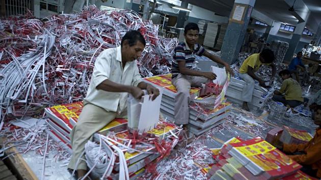 Printed cartons of fmcg majors rolling off the printing machines are sorted and labelled by the workers. Printed cartons of fmcg majors rolling off the printing machines are sorted and labelled by the workers.