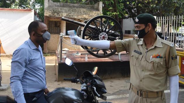 A Bihar Military Police personnel uses a thermal screening device to check a person outside its office in Patna on Wednesday. (Santosh Kumar/HT Photo) A Bihar Military Police personnel uses a thermal screening device to check a person outside its office in Patna on Wednesday. (Santosh Kumar/HT Photo)