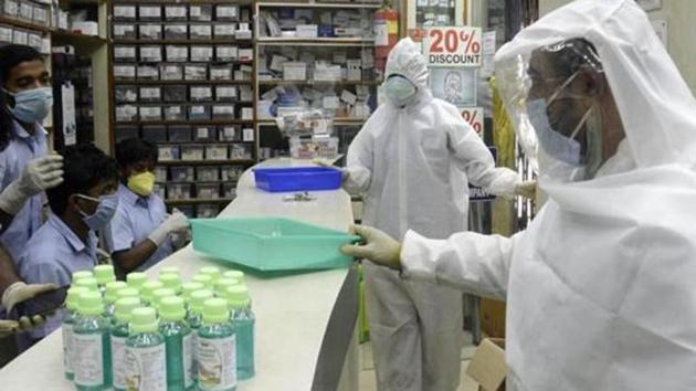 Pharmacy shop workers wear full protective gear during the nationwide lockdown to curb the spread of coronavirus in Kolkata.(ANI PHOTO.) Pharmacy shop workers wear full protective gear during the nationwide lockdown to curb the spread of coronavirus in Kolkata.(ANI PHOTO.)