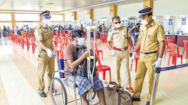 Kerala police personnel led by Inspector General of Police Vijay Sakhare (second from right) assist a differently-abled man after being disembarked by INS Jalashwa carrying repatriated Indian citizens from Maldives, at Cochin Port.(PTI)